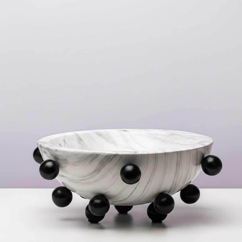 Wide white faux marble bowl with black spherical accents