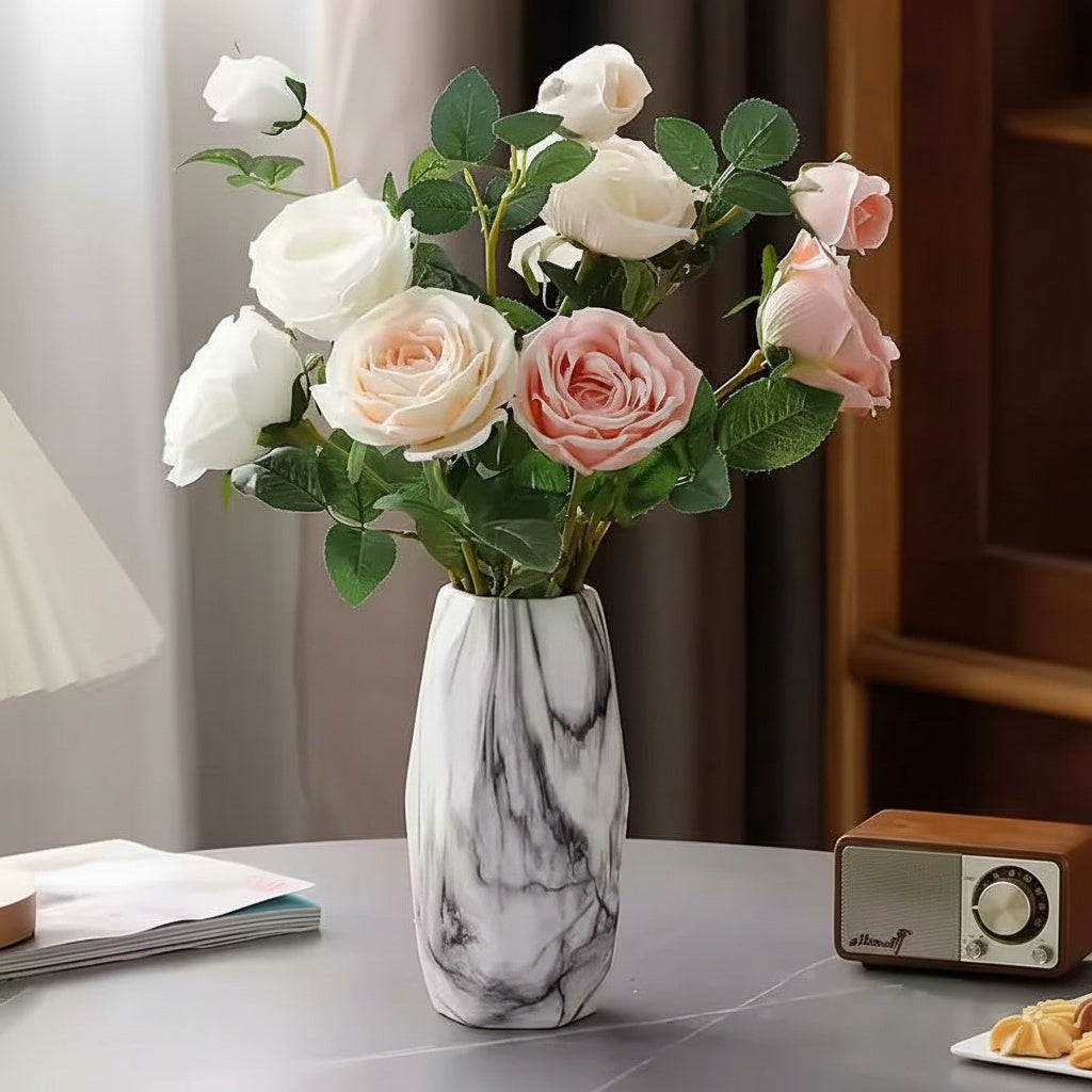 Marble finish ceramic faceted vase with floral arrangement on a table