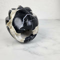 Detail of black marble vase base showing natural veining