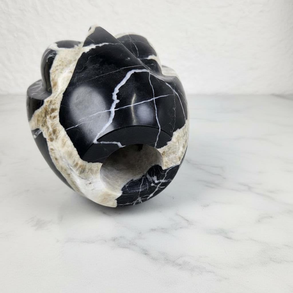 Detail of black marble vase base showing natural veining