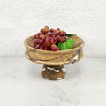 Brown marble pedestal bowl filled with red grapes
