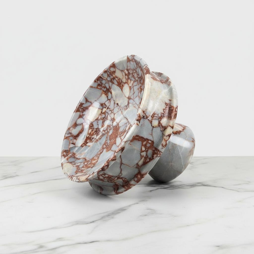 White and burgundy marble footed bowl tilted to show interior