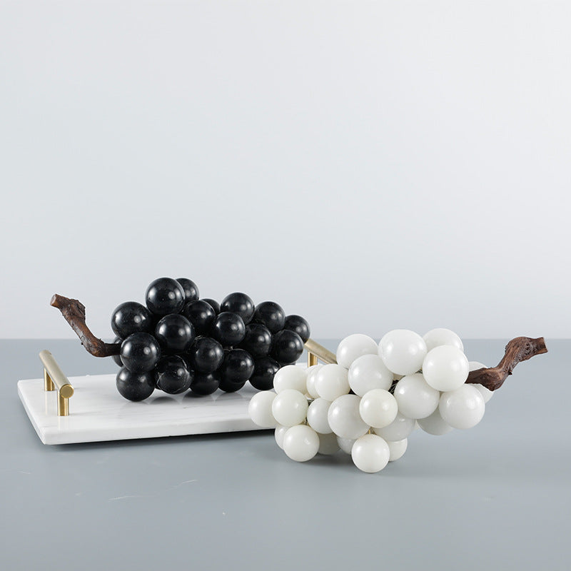 Black and white marble grape sculptures styled on a tray