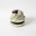 Studio view of green marble diffuser bowl with raw crystals