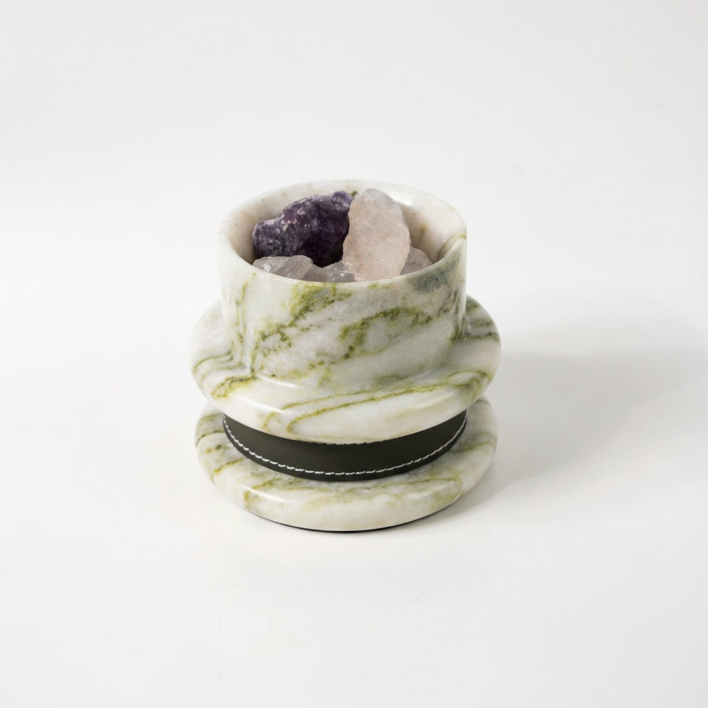 Studio view of green marble diffuser bowl with raw crystals