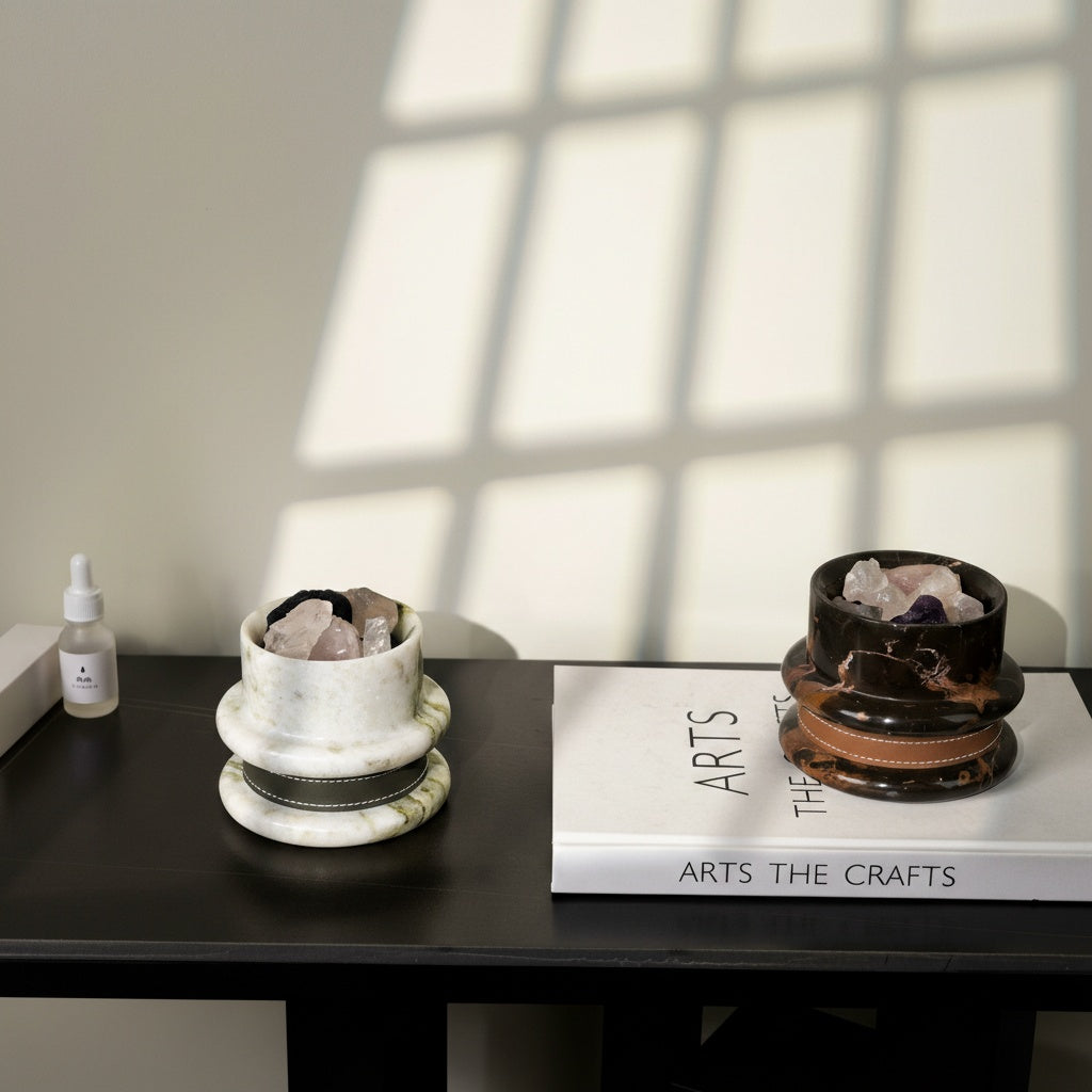 Luxury stone diffusers styled on black console table with art book