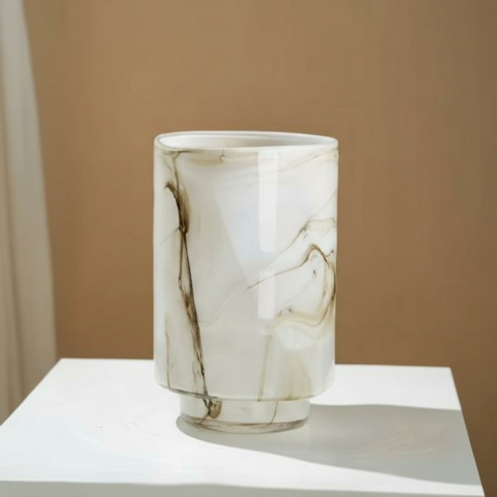 Close up of cream and brown marble-pattern glass cylindrical vase