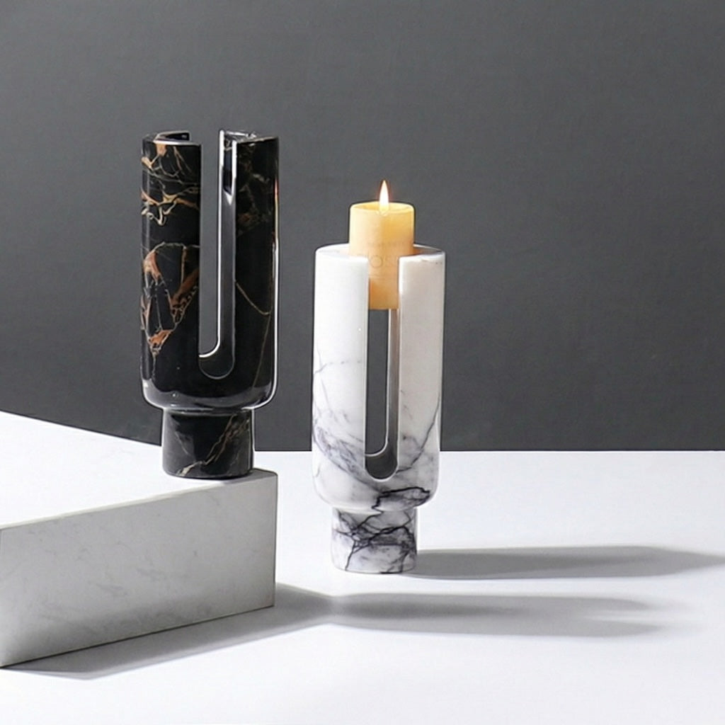 Lifestyle shot of black and white marble candle holders with lit candle