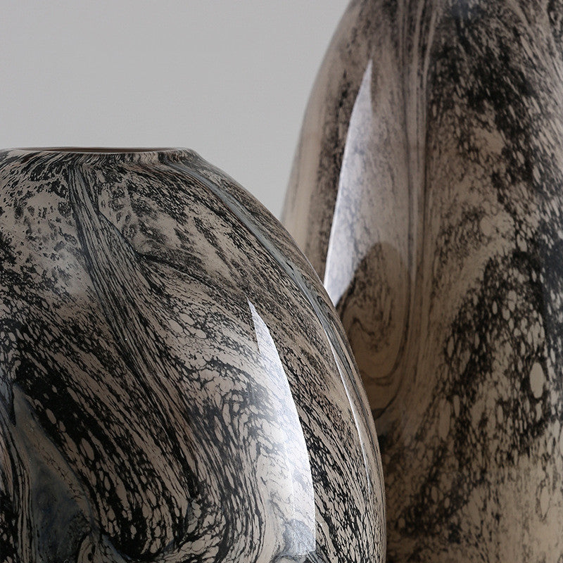 Close up detail of black and beige swirl pattern on glass surface