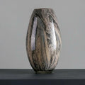 Front view of tall tapered marbled glass vase