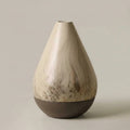 Front view of marbled ceramic teardrop vase on neutral background