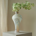 Marbled frosted glass vase with green orchids
