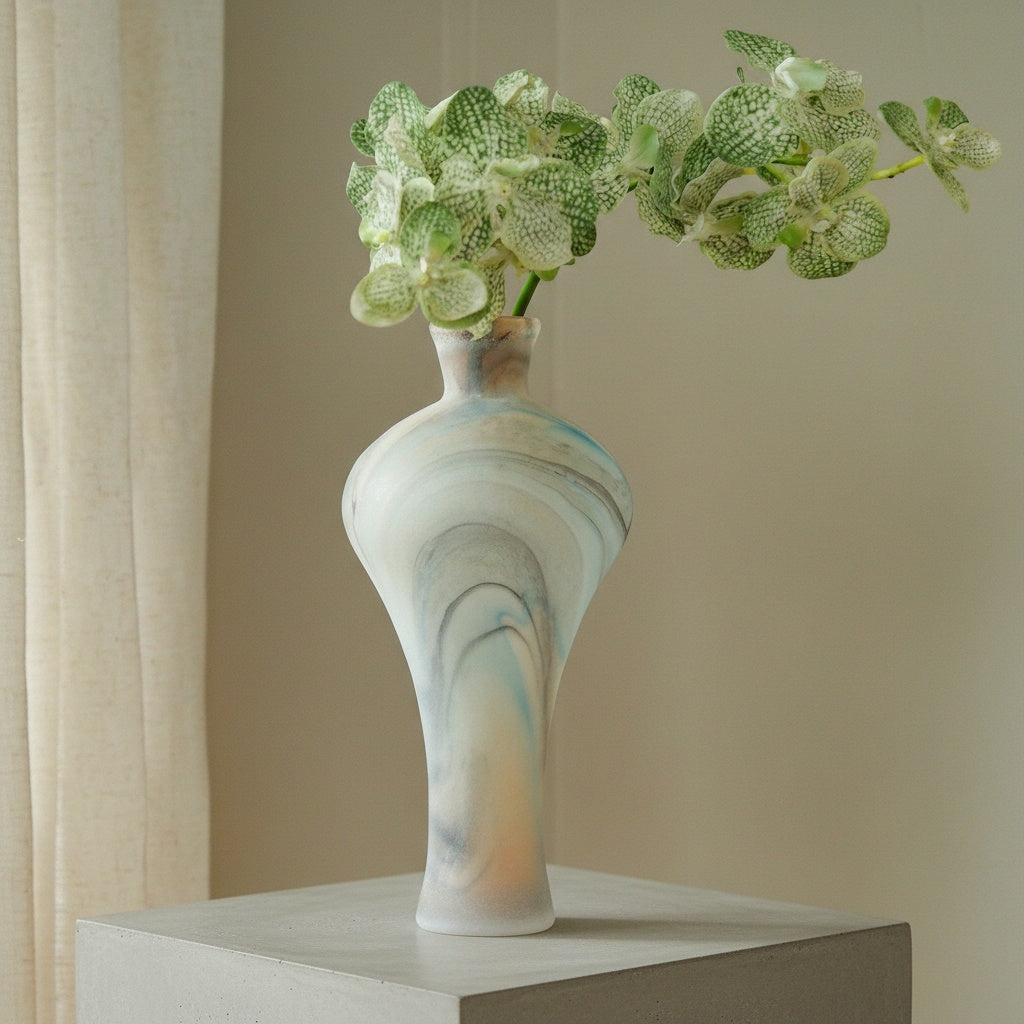 Marbled frosted glass vase with green orchids