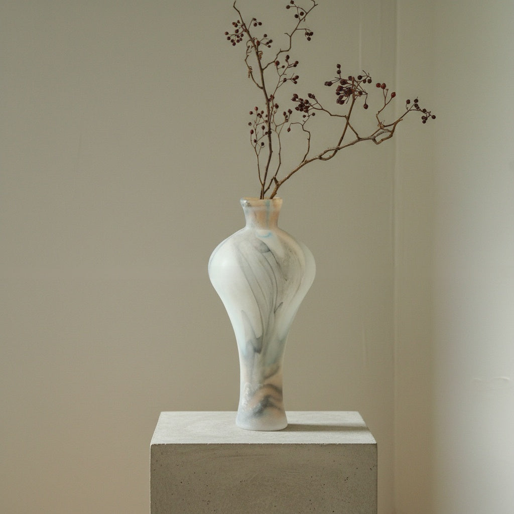 Sculptural frosted glass vase with dried branches