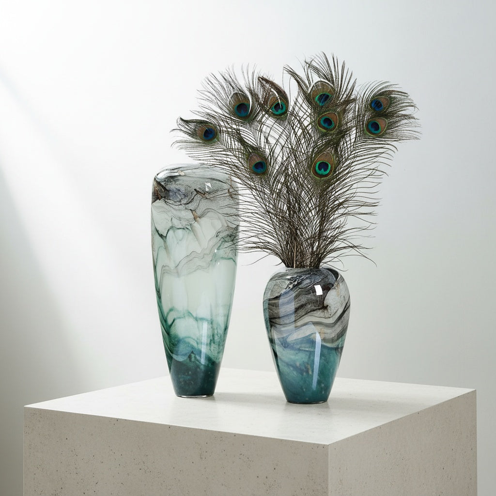 Marbled teal and grey glass vases styled with peacock feathers