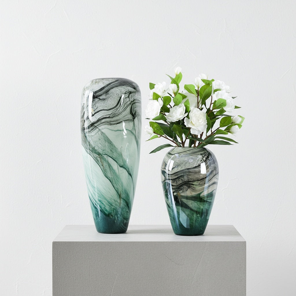 Short and tall marbled glass vases with white flowers