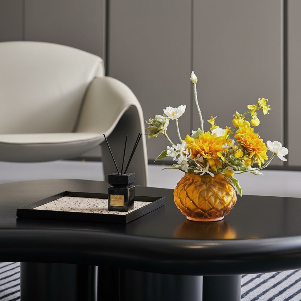 Matte Amber Glass Geometric Vase holding flowers on a dark table