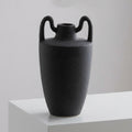 Matte black ceramic vase with dual handles and textured finish