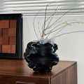 Matte Black Ceramic Ruffled Vase on Wooden Cabinet