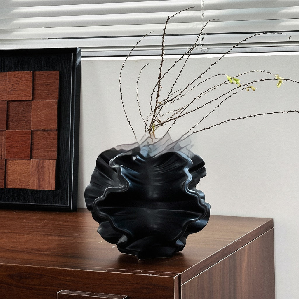 Matte Black Ceramic Ruffled Vase on Wooden Cabinet