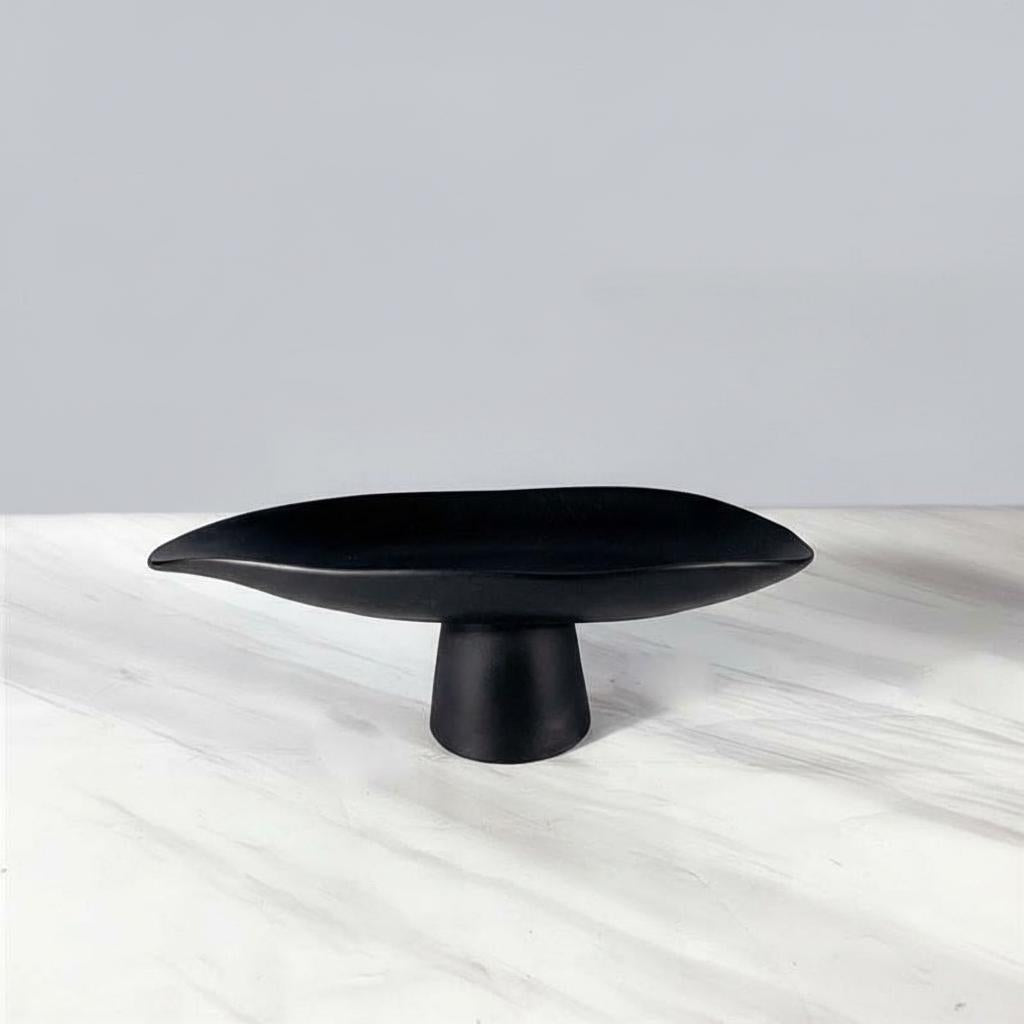 Medium matte black resin footed tray empty on white background