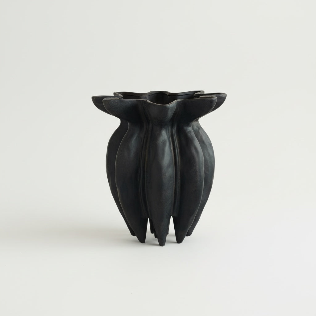 Matte black sculptural fluted vase empty showing ribbed texture