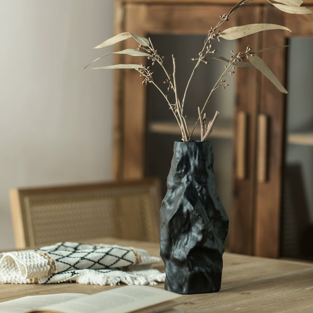 Close up of sculptural black ceramic vase texture