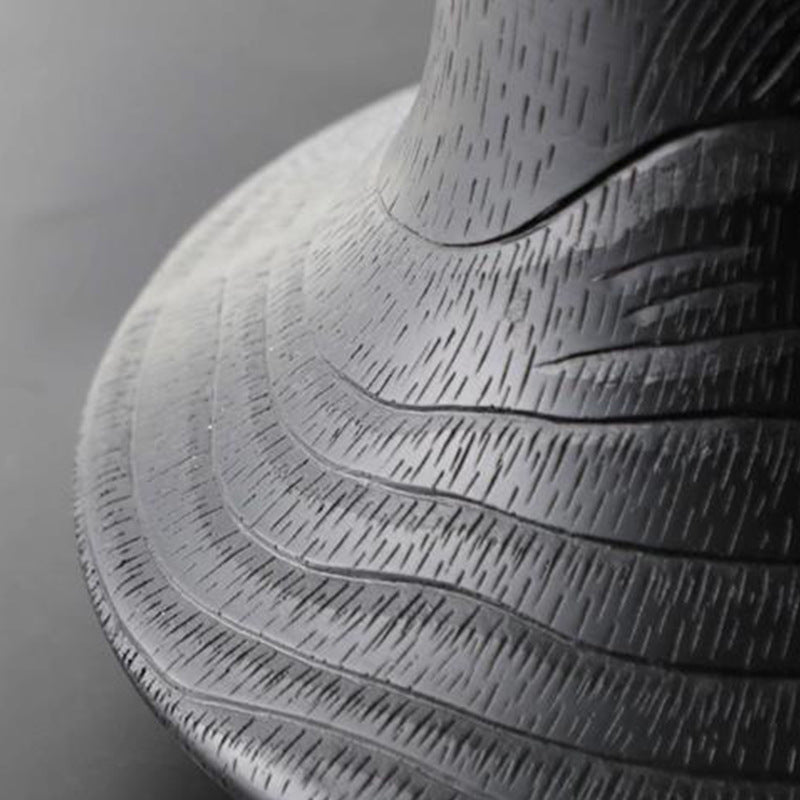 Close up detail of the raked wood grain texture on black resin