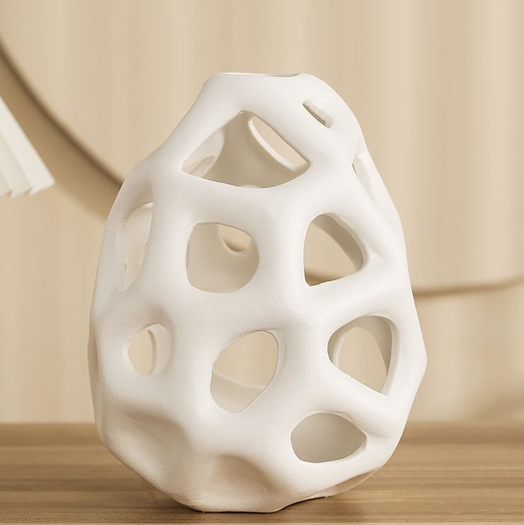 Close up detail of white matte ceramic hollow vase