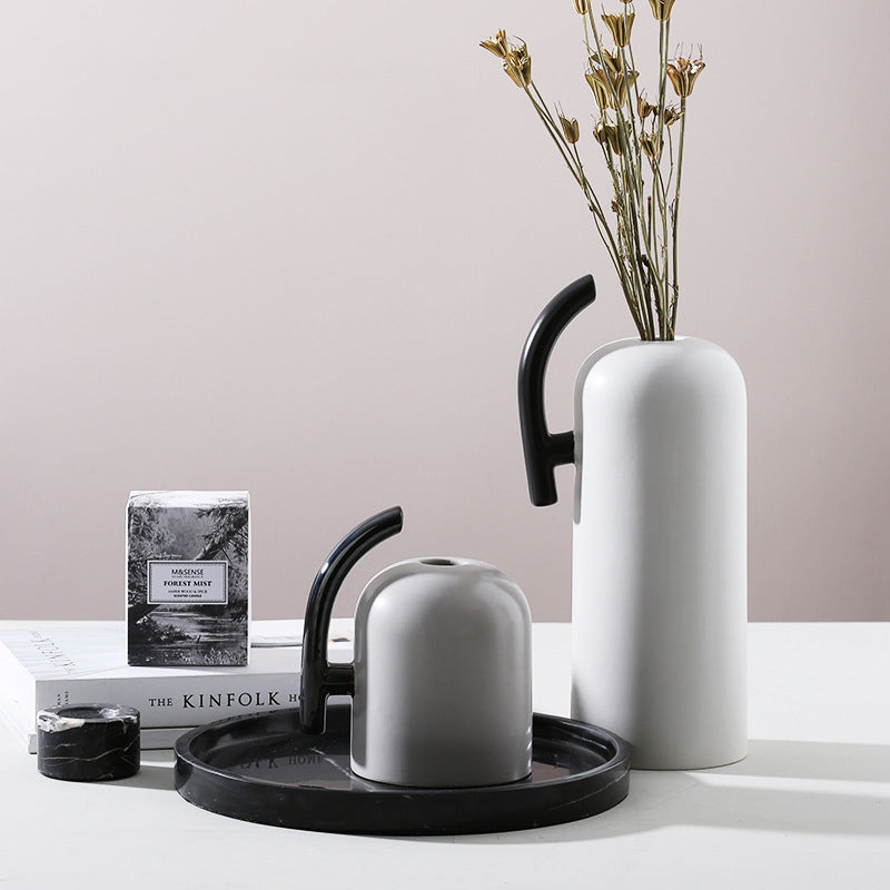 Group shot of ceramic vases with contrasting handles