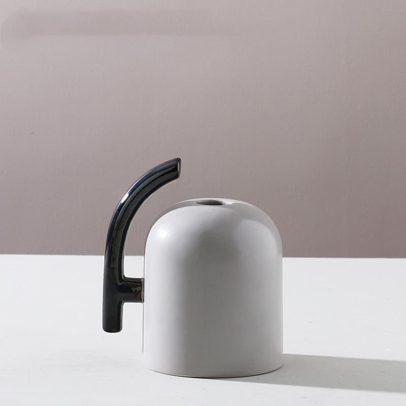 Small grey ceramic vase with black handle