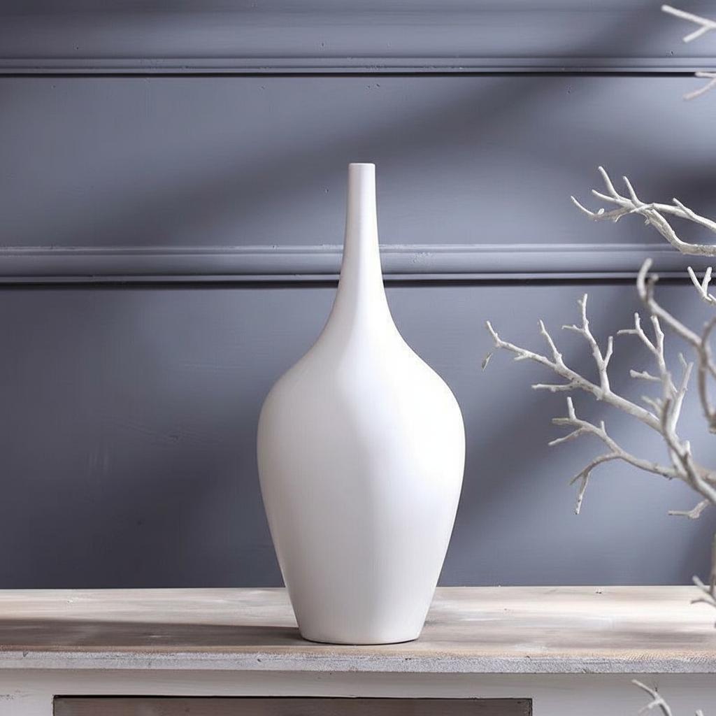 Close up of white matte ceramic vase with dry branches