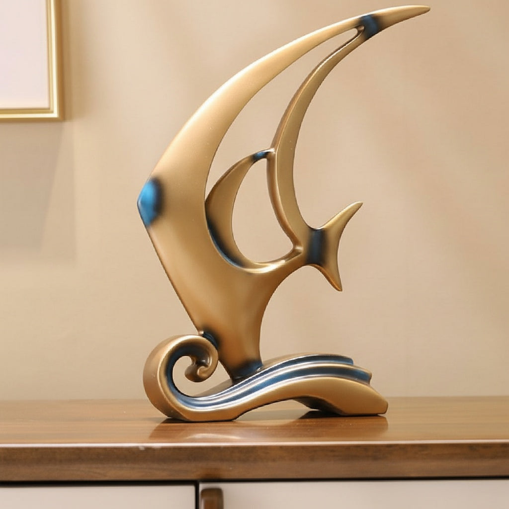 Side view of matte gold abstract fish sculpture with blue accents