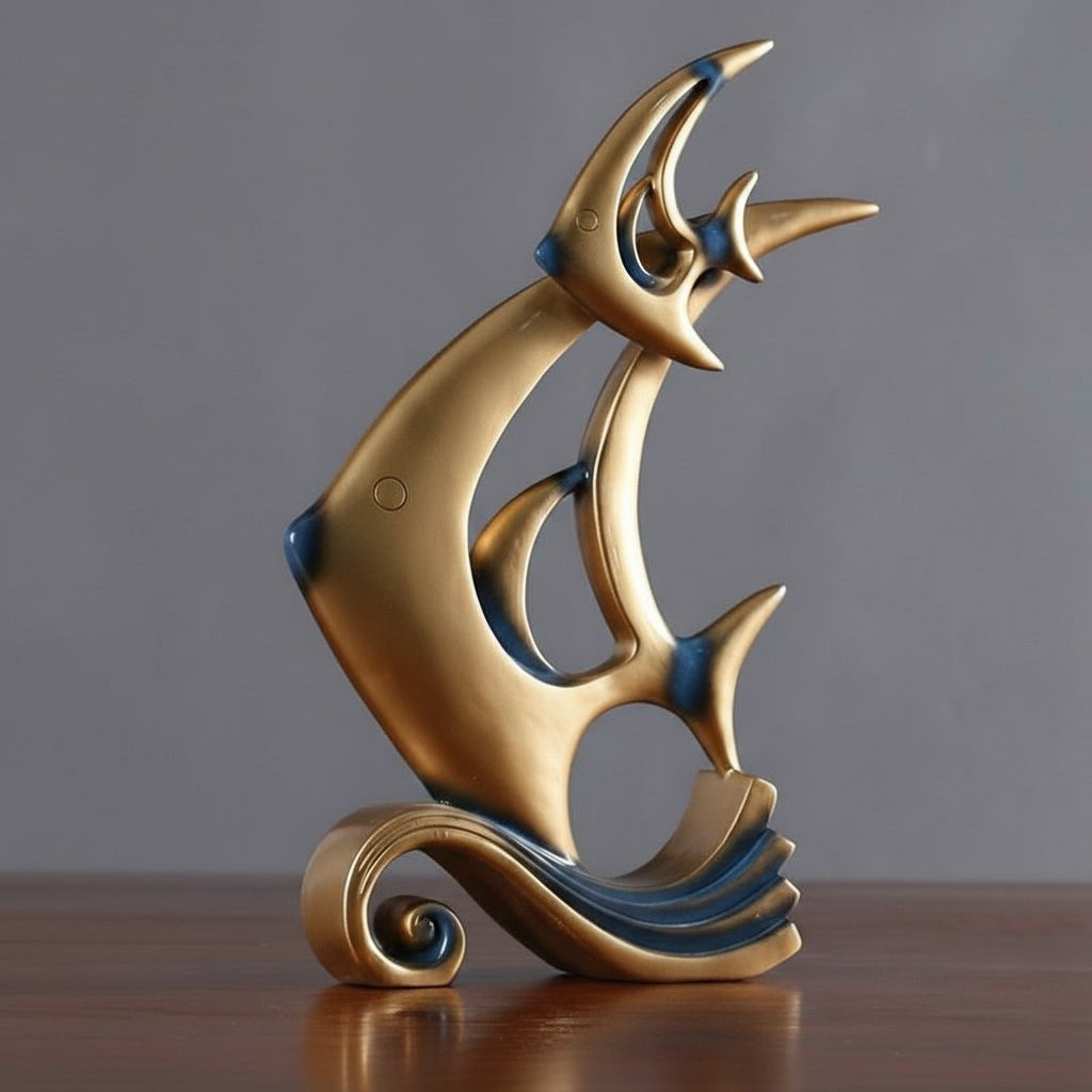 Front angle of gold and blue resin fish statue on wave base