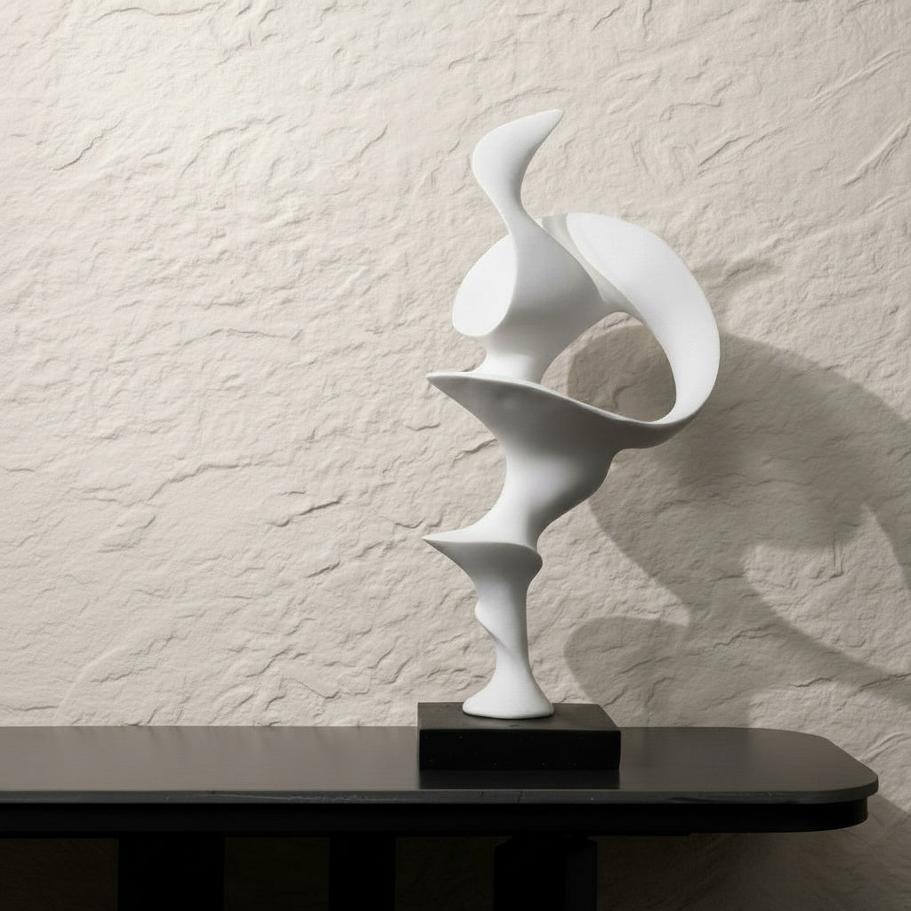 Matte White Abstract Sculpture on black table against textured wall