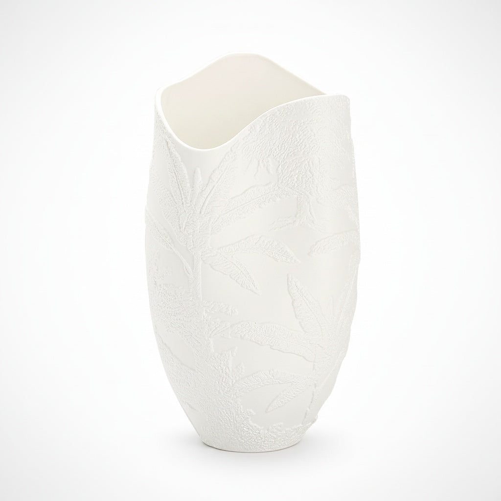 Close up of matte white ceramic vase showing botanical texture