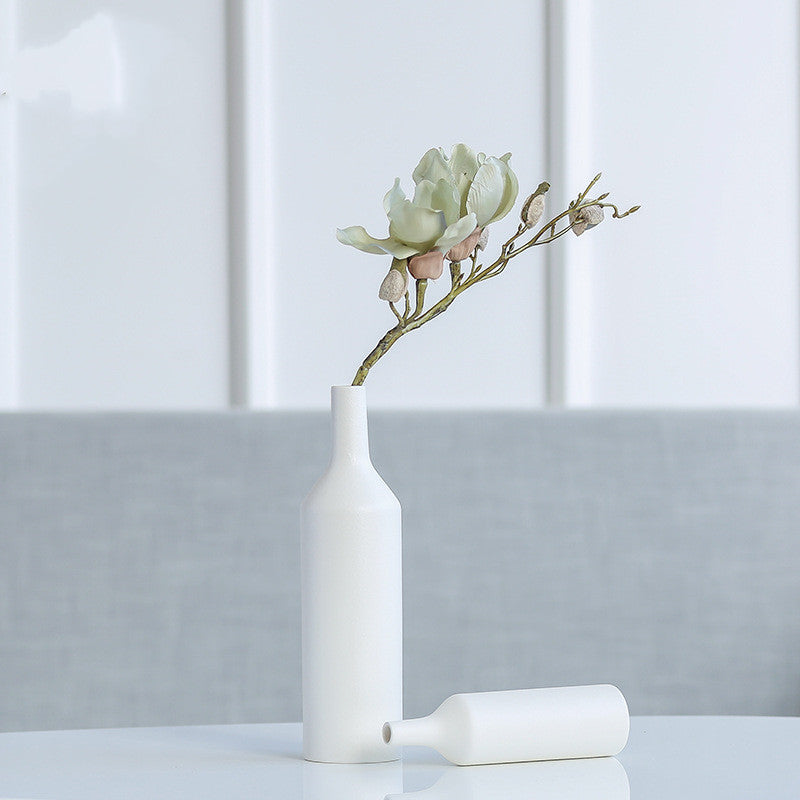 Ceramic bottle vase with pastel flowers in modern setting
