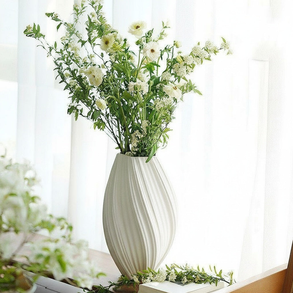 Matte White Ceramic Ribbed Oval Vase styled with fresh white flowers