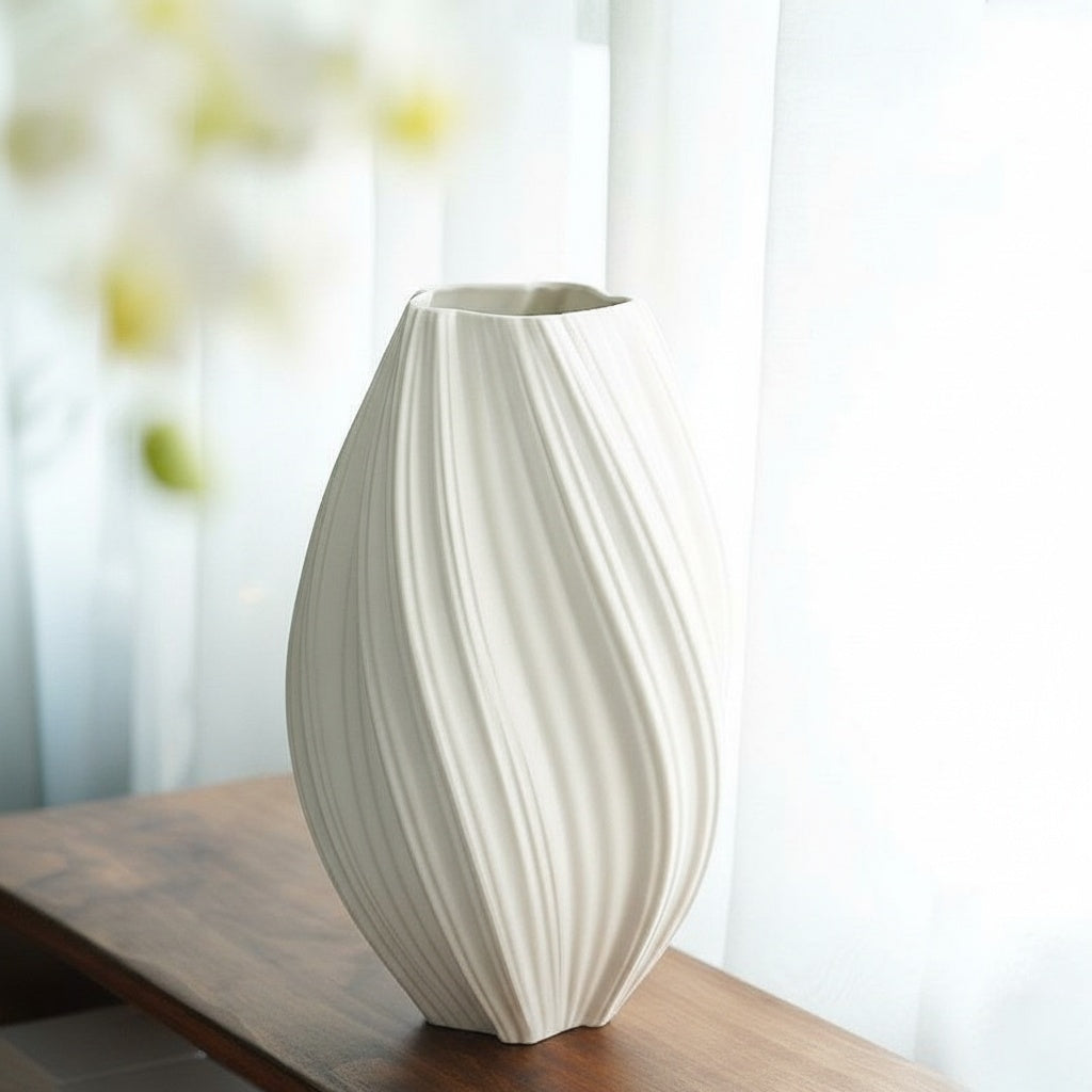 Matte White Ceramic Ribbed Oval Vase resting on a wooden console