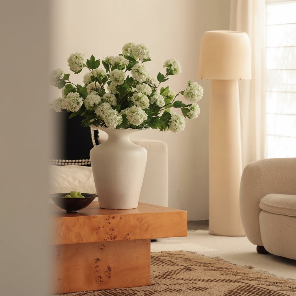 Matte White Ceramic Ruffled Rim Vase on Wooden Coffee Table