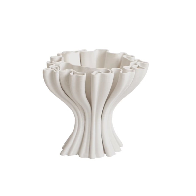 Studio shot of empty matte white ruffled ceramic vase