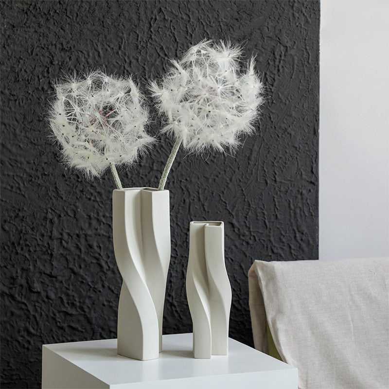 Matte white ceramic twisted vase with dandelion flowers