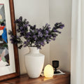 Matte white ceramic urn vase with purple foliage