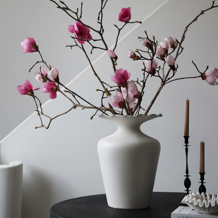 Matte white scalloped ceramic vase styled with branches