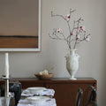 Matte White Sculpted Amphora Vase styled on a wooden console with branches