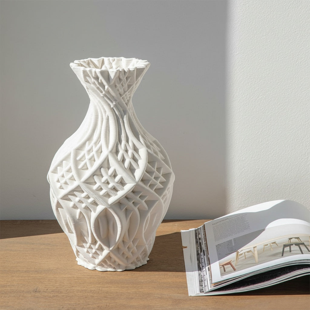 Matte white sculptural vase styled on a wooden table with a magazine