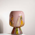 Medium tall mauve glass pedestal vase with abstract design