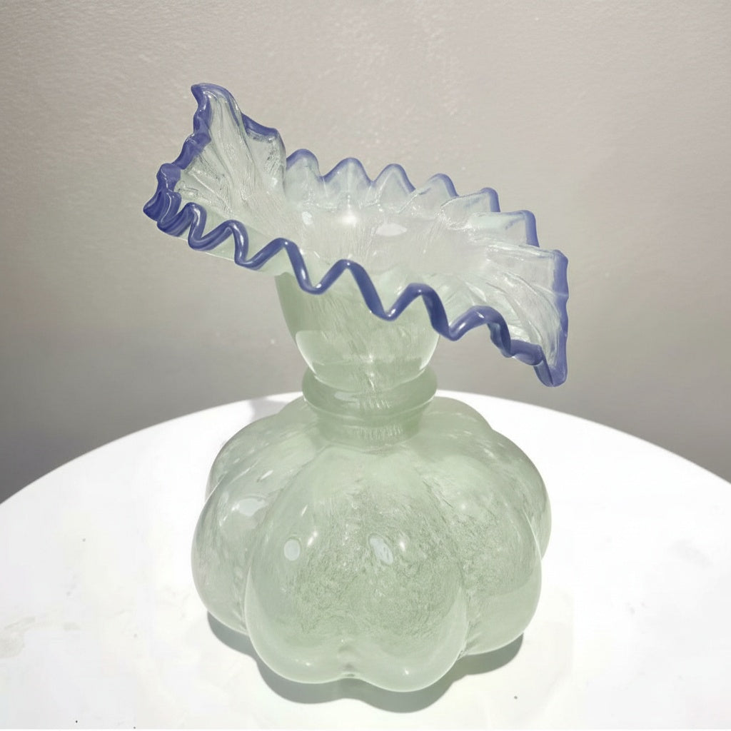 Empty mint green glass vase with pumpkin base and ruffled blue rim