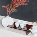 Side angle of luxury marble decor piece with tea cups displayed on the extended shelf
