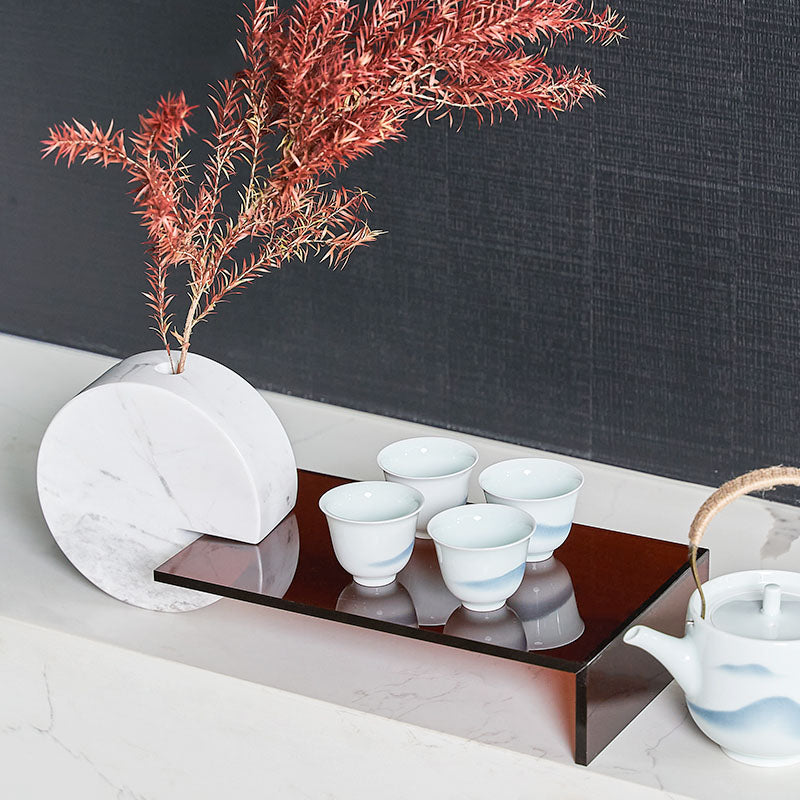 Side angle of luxury marble decor piece with tea cups displayed on the extended shelf